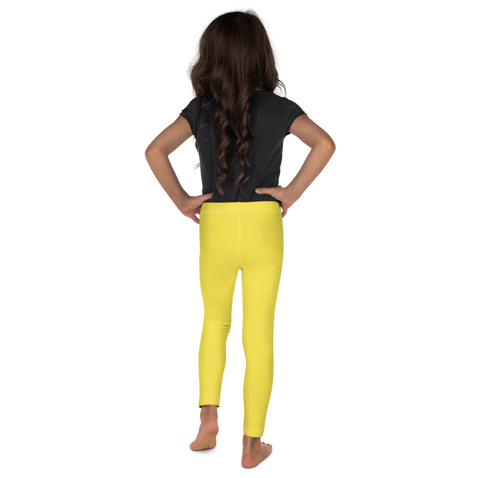 Bright yellow kids buttery soft leggings shown from the back in a form-fitting comfortable style
