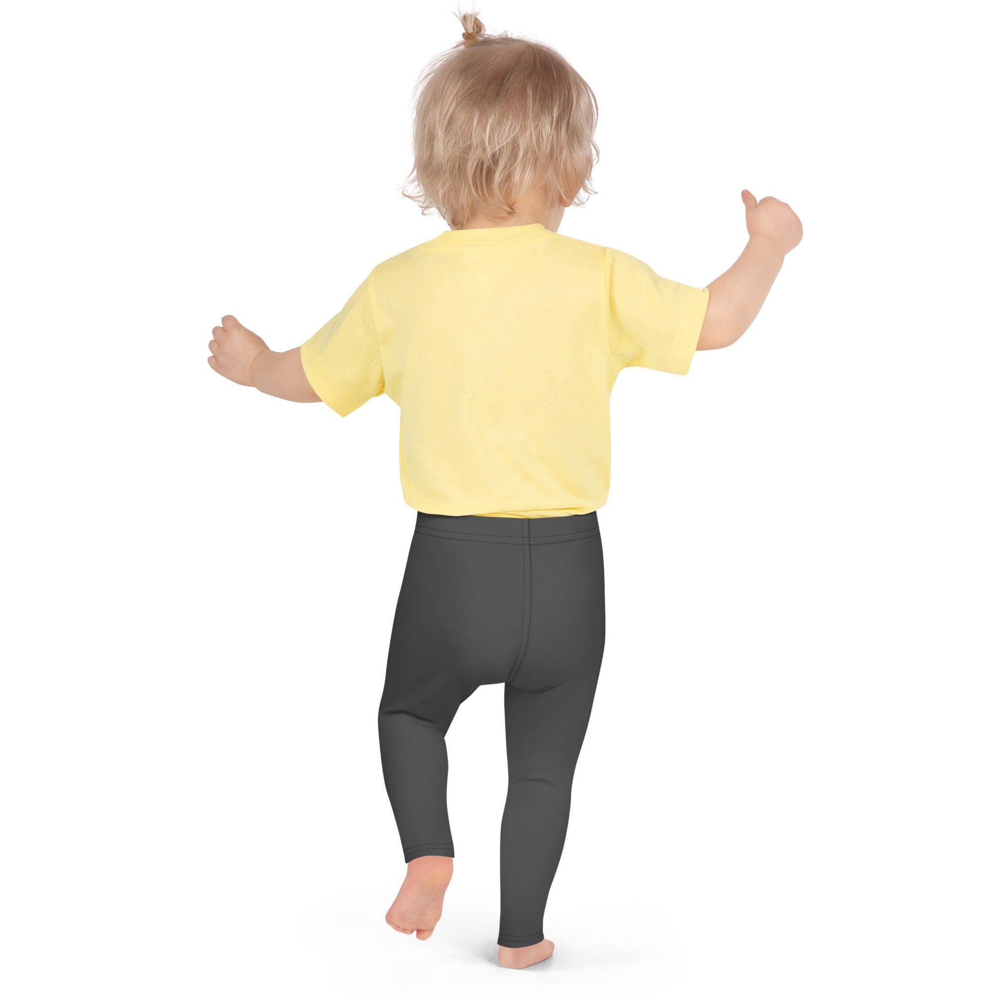 A toddler wearing bright yellow short-sleeved tee and dark gray buttery soft kids leggings from front view