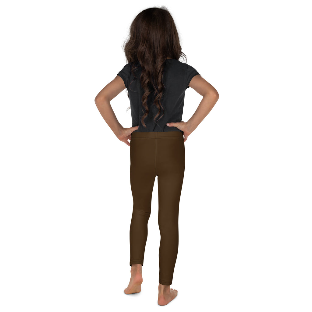 Child wearing buttery soft brown leggings standing with hands on hips showcasing comfortable fit