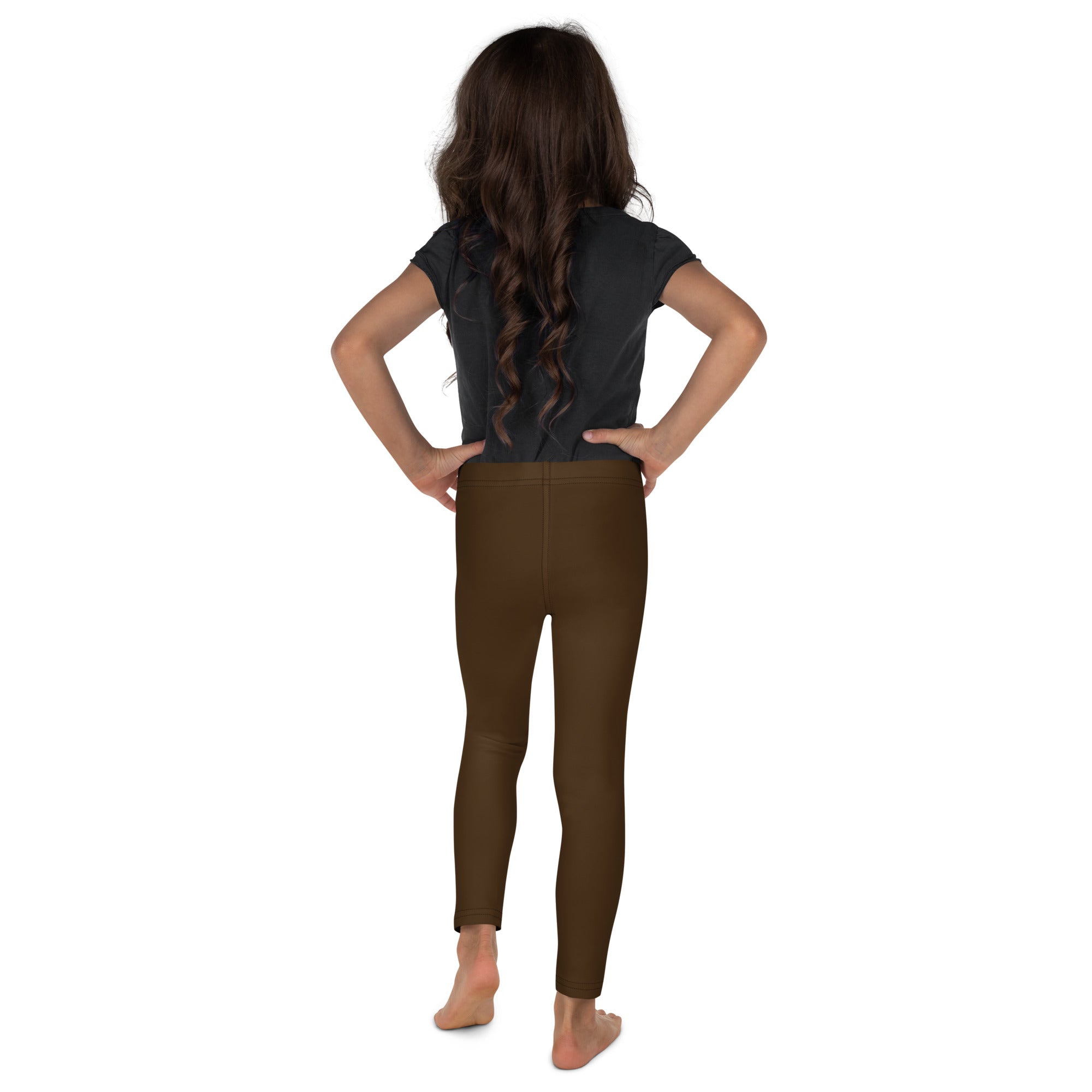 Child wearing buttery soft brown leggings standing with hands on hips showcasing comfortable fit
