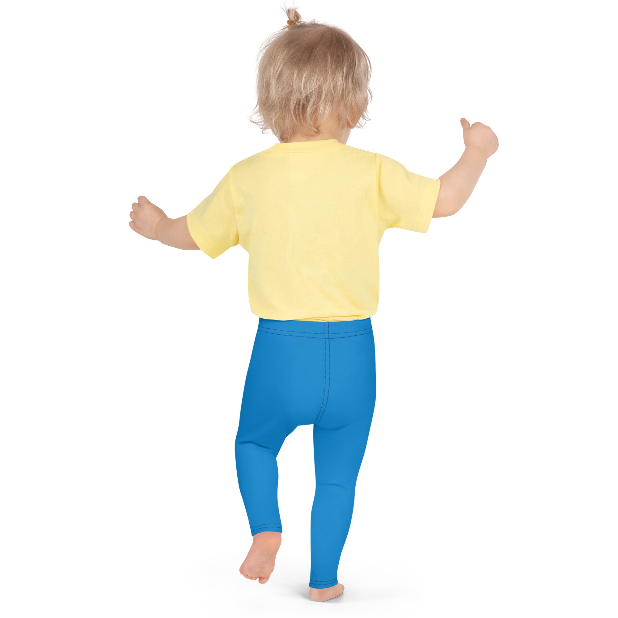 A toddler wearing kids buttery soft blue leggings made of soft comfortable fabric paired with a yellow shirt