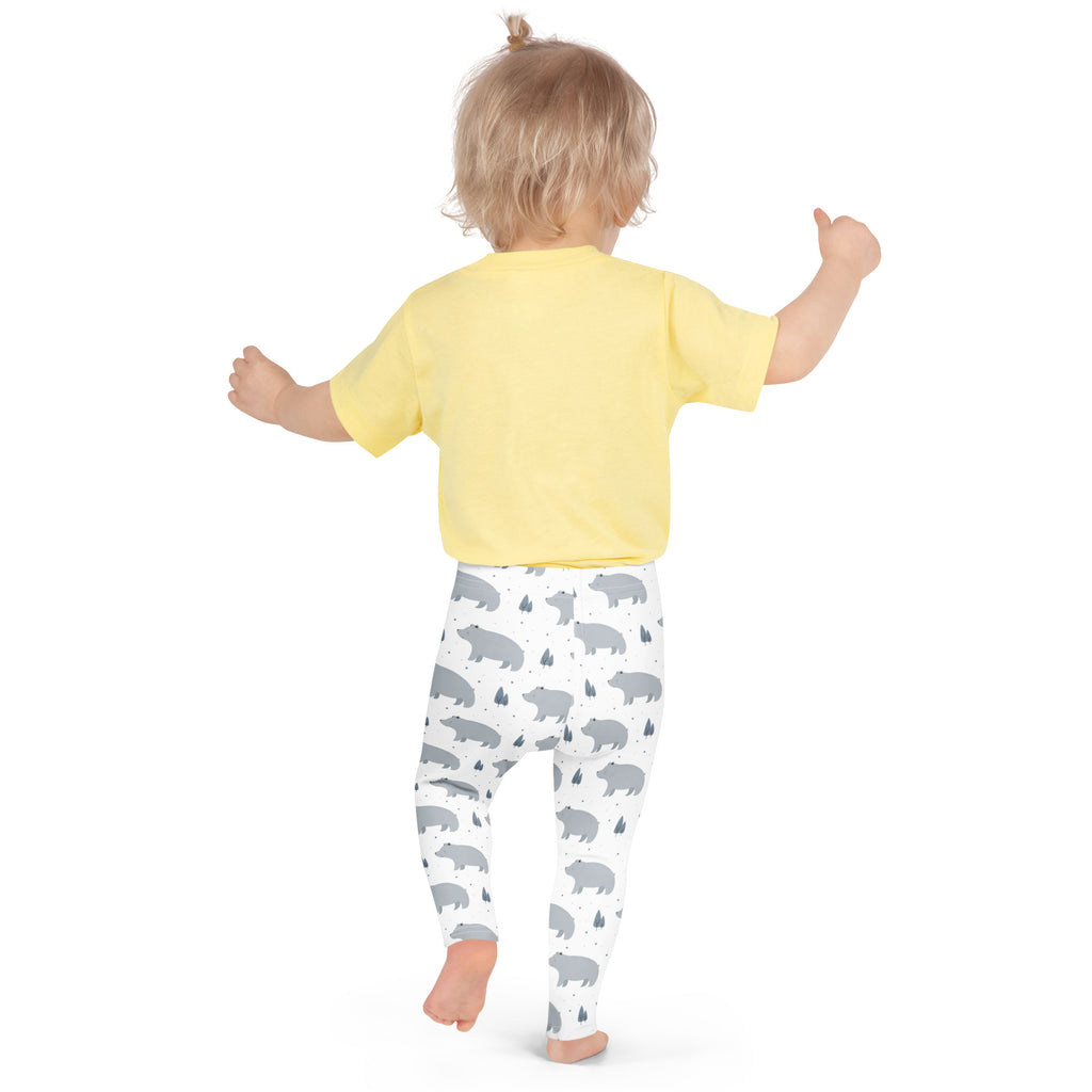 A child wearing girls polar bear buttery soft white leggings with gray bear prints and a yellow short-sleeved shirt