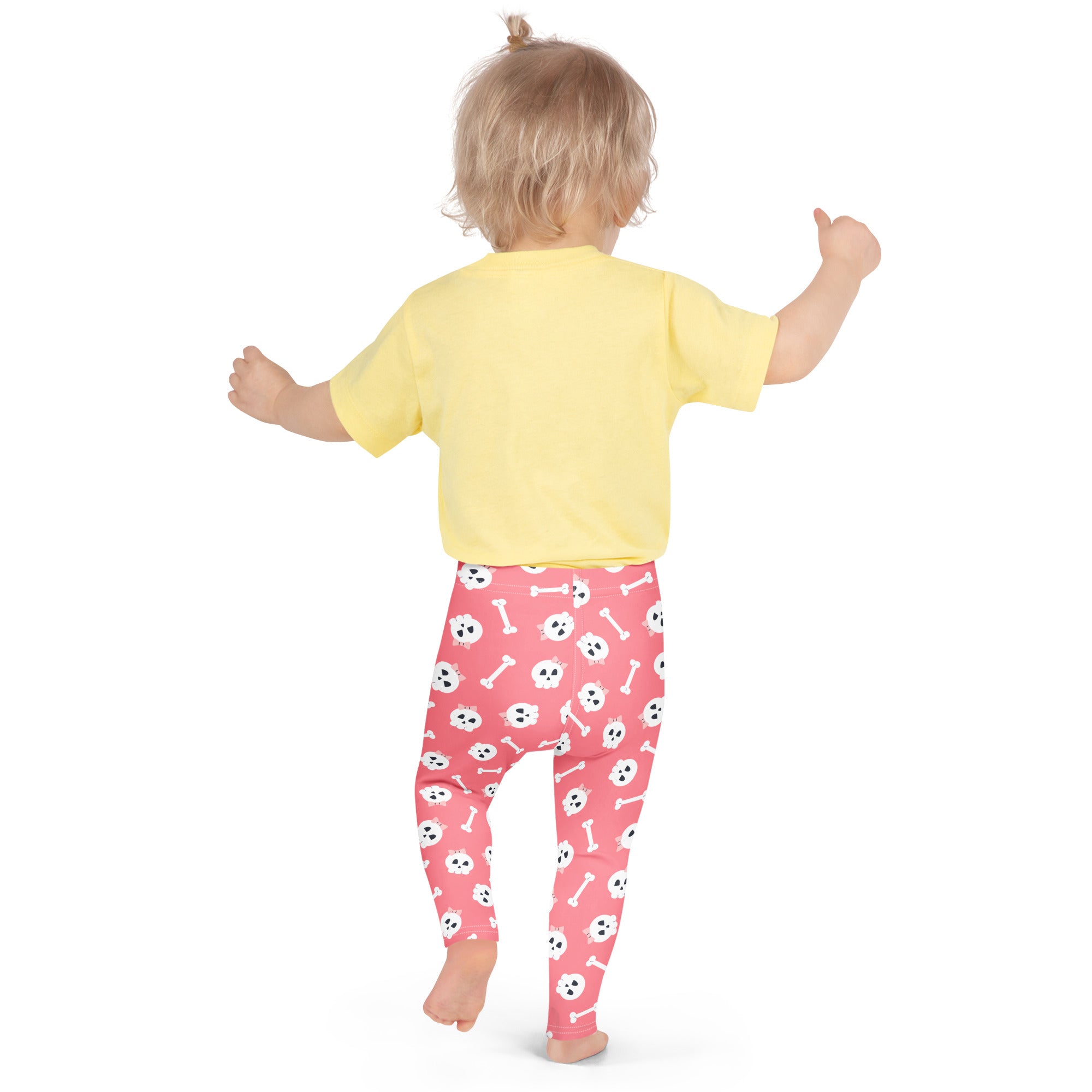 Girls pink buttery soft leggings with white skulls and bones playful pattern perfect for halloween wear