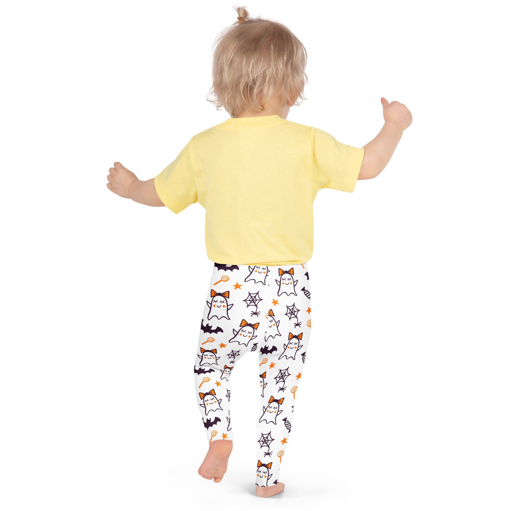 A child wears girls cute ghost bow buttery soft white leggings with playful halloween ghost and candy motifs
