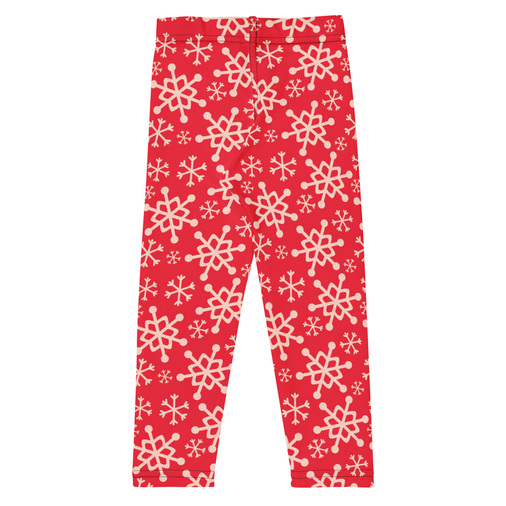 Kids red snowflake buttery soft leggings featuring a playful cream-colored snowflake pattern on red fabric