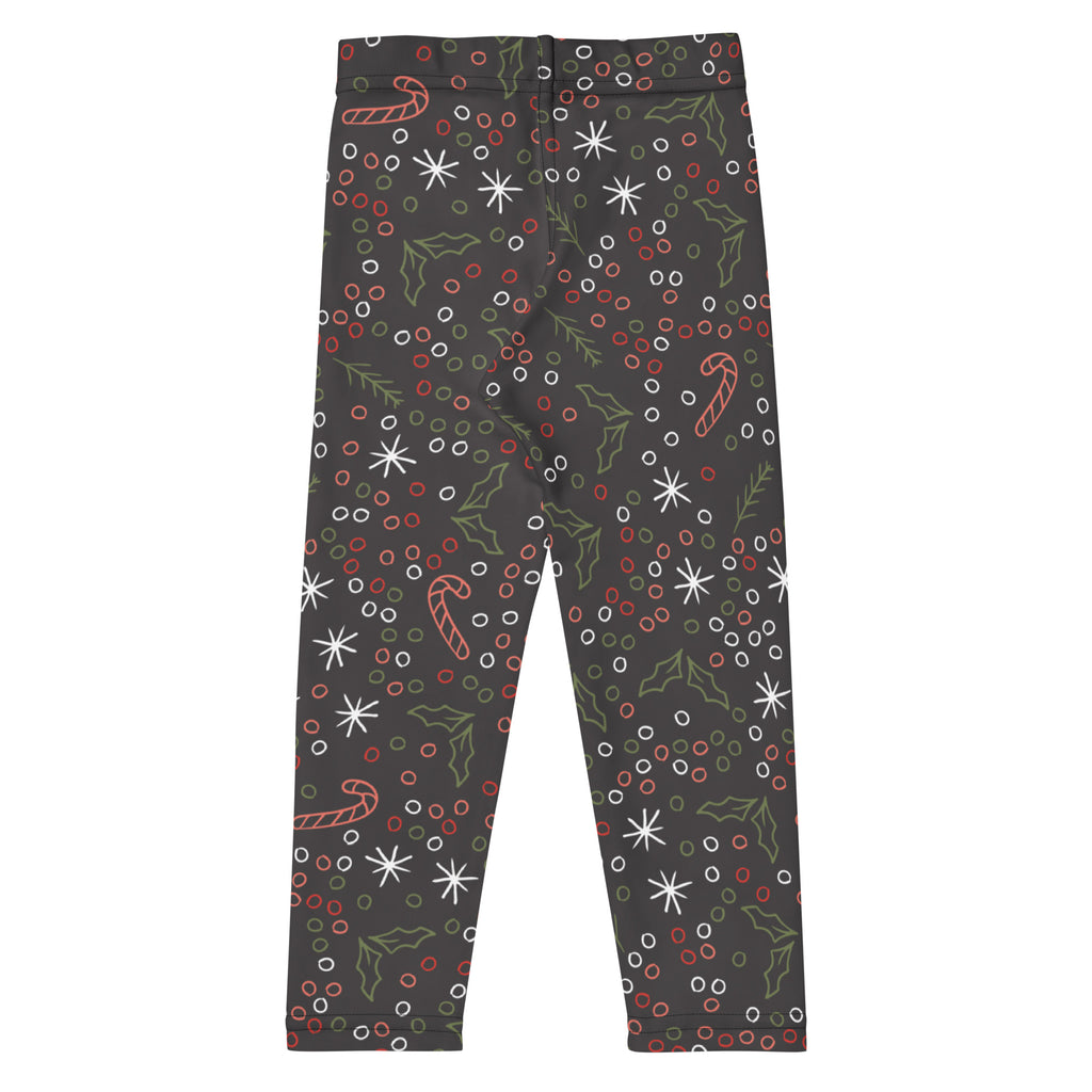 Dark gray kids Christmas leggings with buttery soft fabric featuring candy canes holly leaves snowflakes and berries