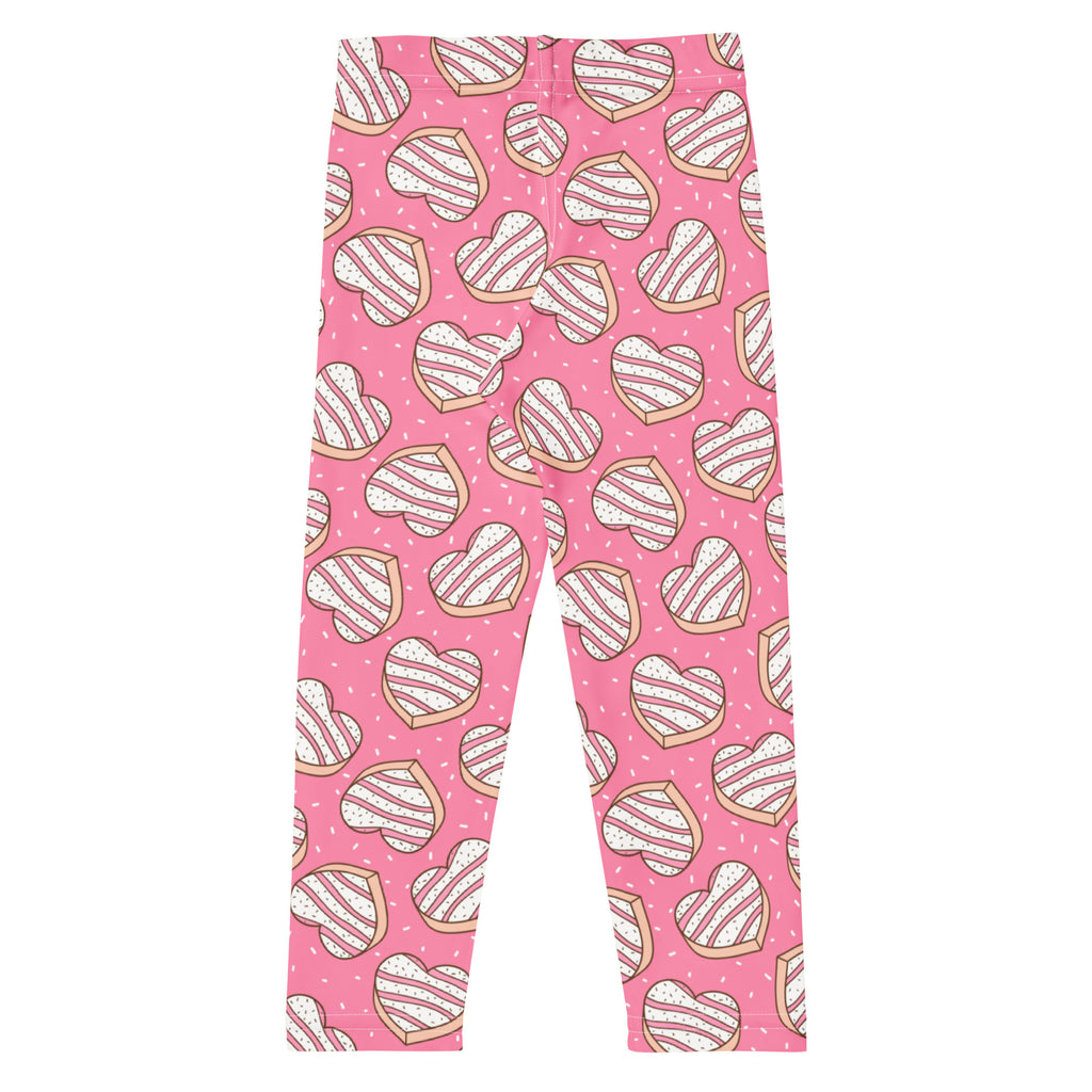 Girls pink buttery soft leggings with playful heart shaped cookie pattern featuring white icing stripes and brown outlines