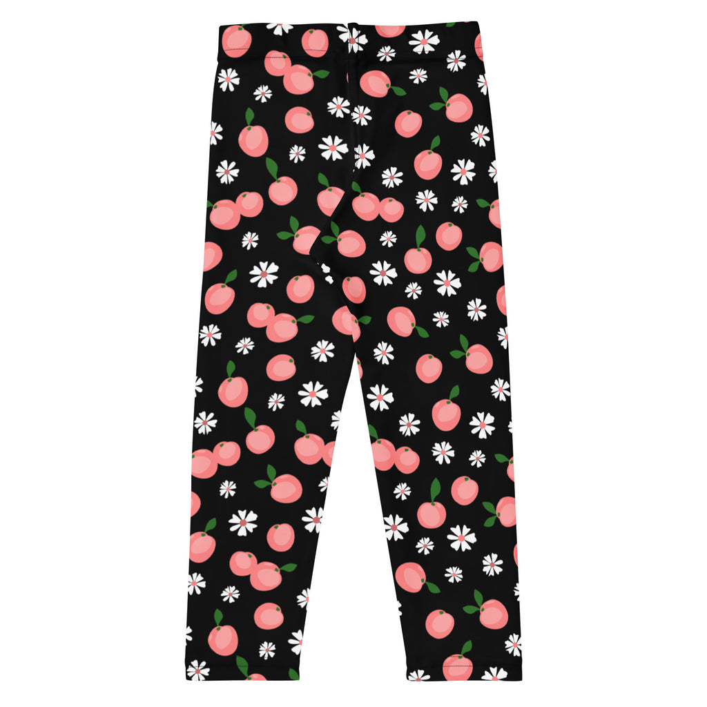 Black buttery soft girls leggings with a playful peach blossom print featuring pink peaches and white daisies