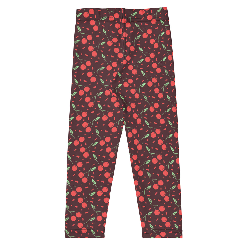 Dark brown girls cherry print buttery soft leggings with playful red cherries green leaves and pink sprinkles pattern