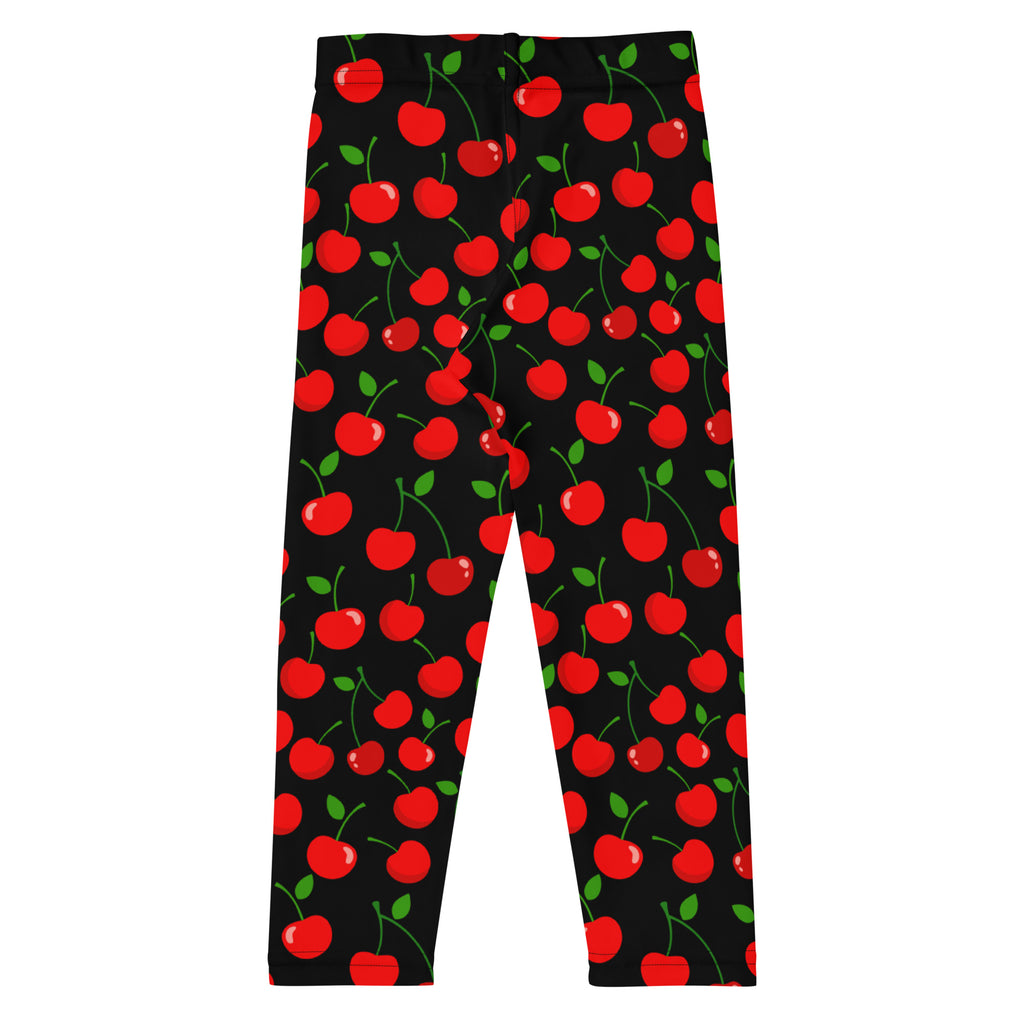 Girls black buttery soft leggings with vibrant red cherry pattern featuring green stems and leaves