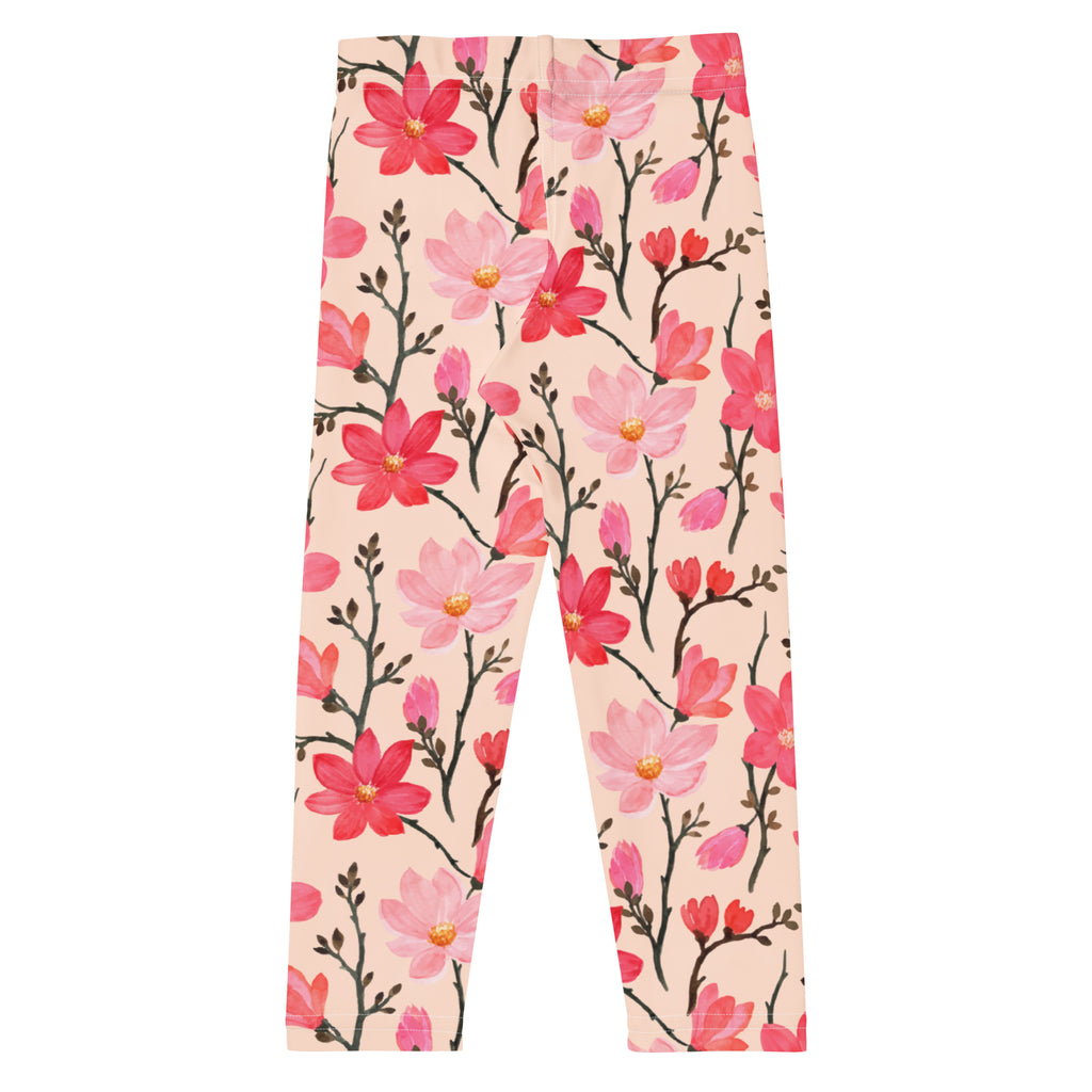 Girls pink buttery soft leggings with watercolor floral design and delicate black stems on soft peach background