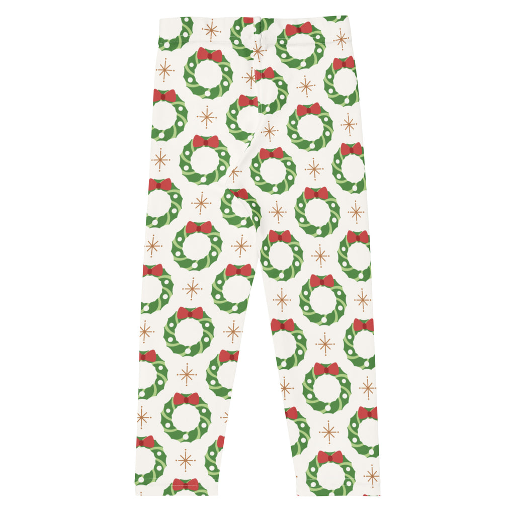 Kids holiday wreath buttery soft white leggings with green wreaths red bows and gold starburst accents pattern