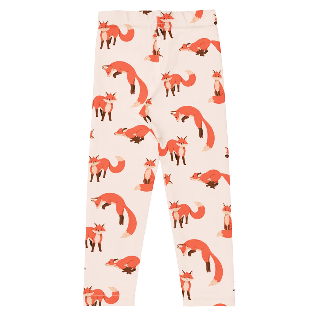 Cream-colored buttery soft kids leggings with playful orange fox print in various poses