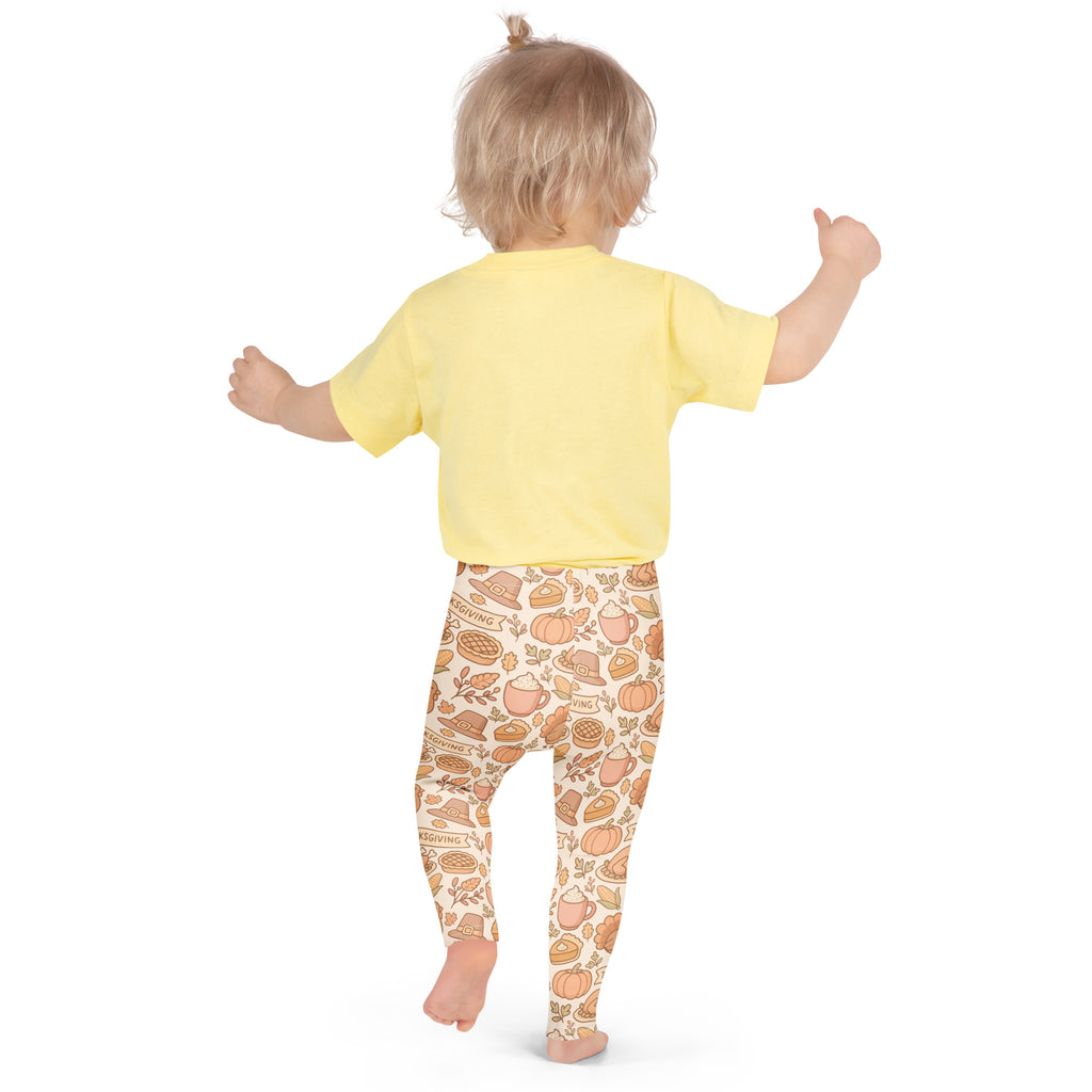 Kids thanksgiving buttery soft leggings beige with autumn pumpkin pie leaf pattern paired with yellow short sleeve shirt