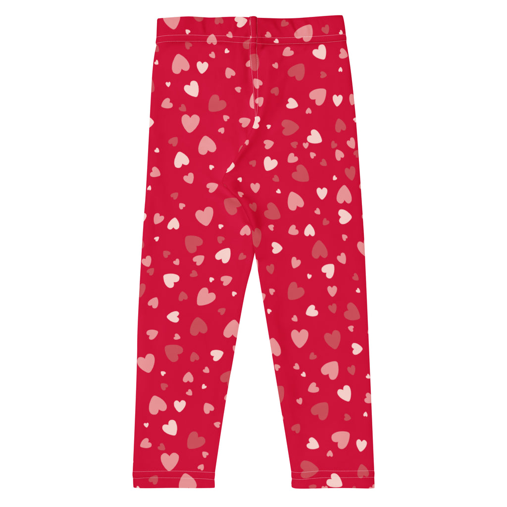 Girls red heart print buttery soft leggings with stretchy fabric and pink and white hearts scattered across design