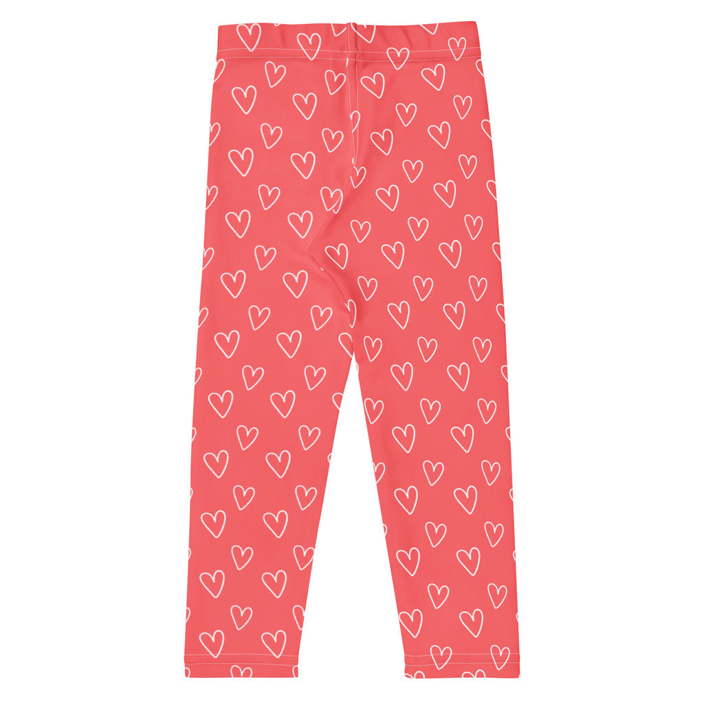 Girls pink buttery soft leggings with white heart outlines featuring a playful all over pattern
