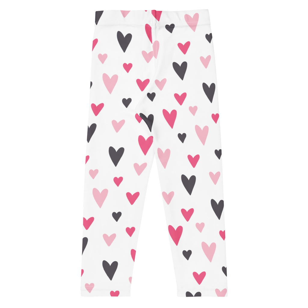 Girls Valentine’s Day white buttery soft leggings with playful pink and black heart pattern for festive wear