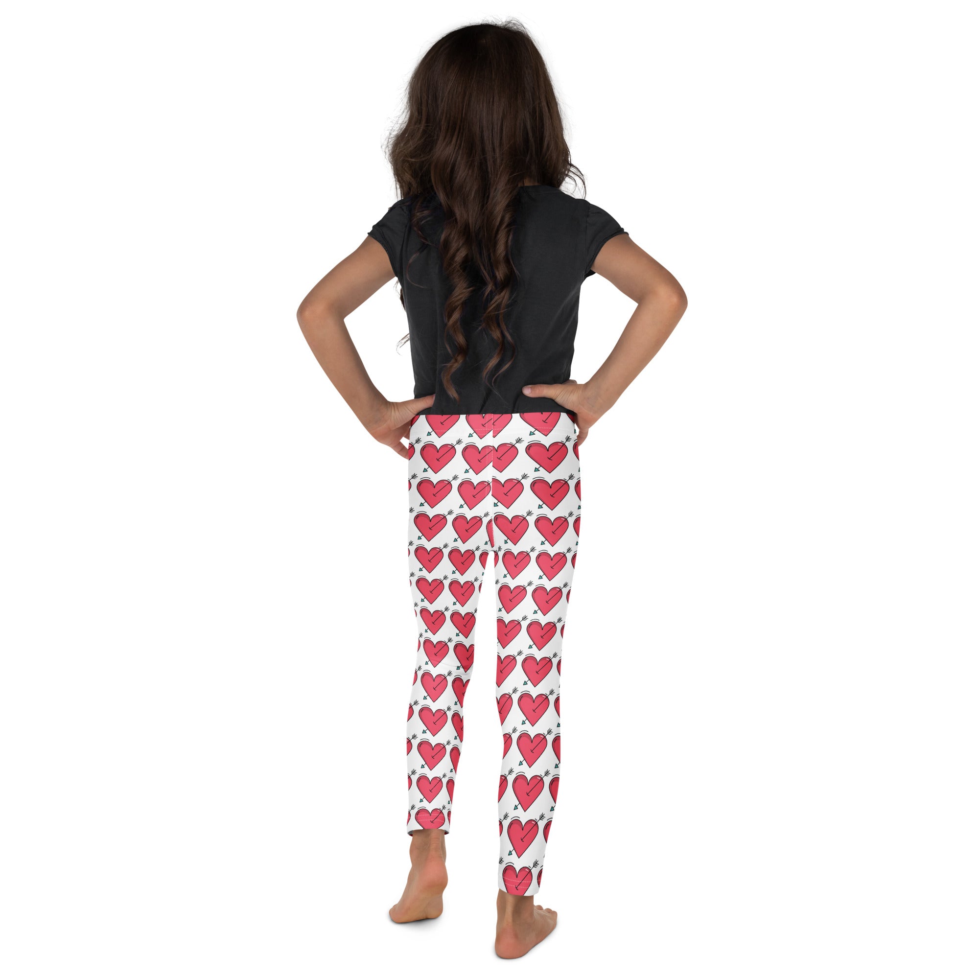 White girls buttery soft leggings with vibrant pink hearts and black outlines perfect for valentine’s day