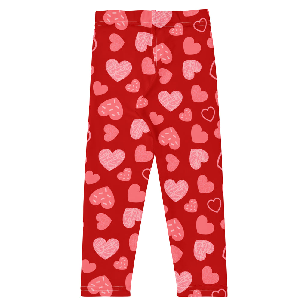 Girls red buttery soft leggings with playful pink heart pattern in various sizes and styles