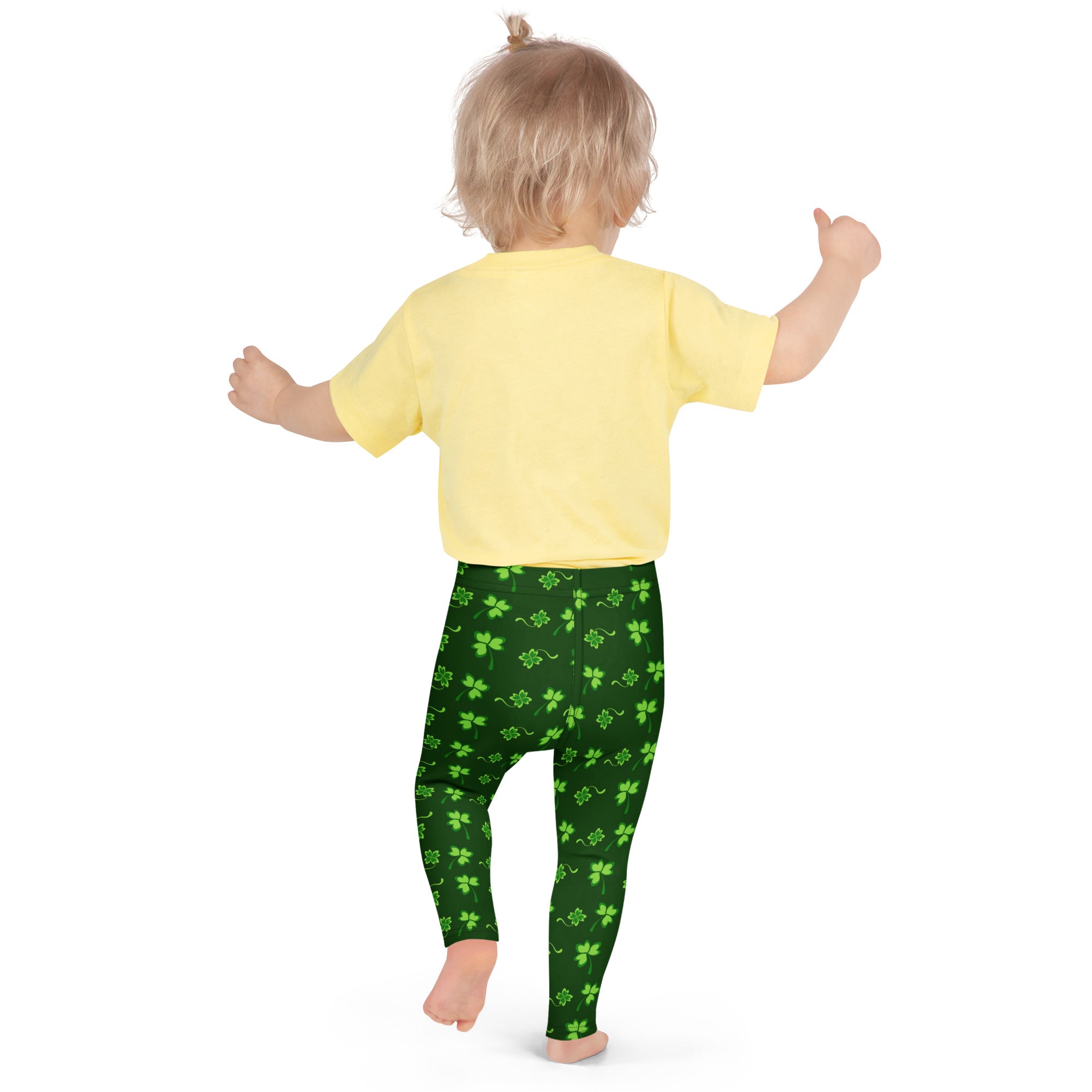 Girls green lucky clover buttery soft leggings with bright green shamrock pattern on dark green background
