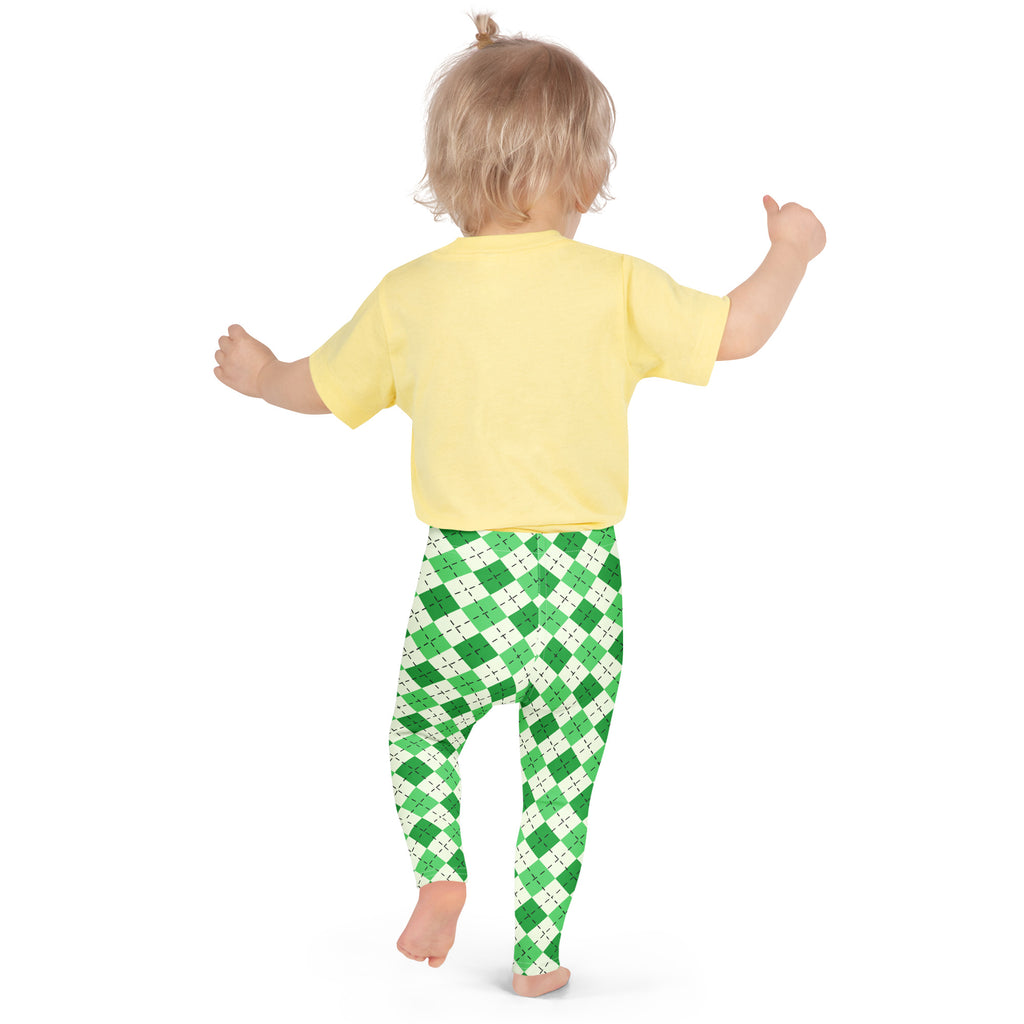 A child wearing girls green argyle st patricks day buttery soft leggings and a yellow short sleeved top