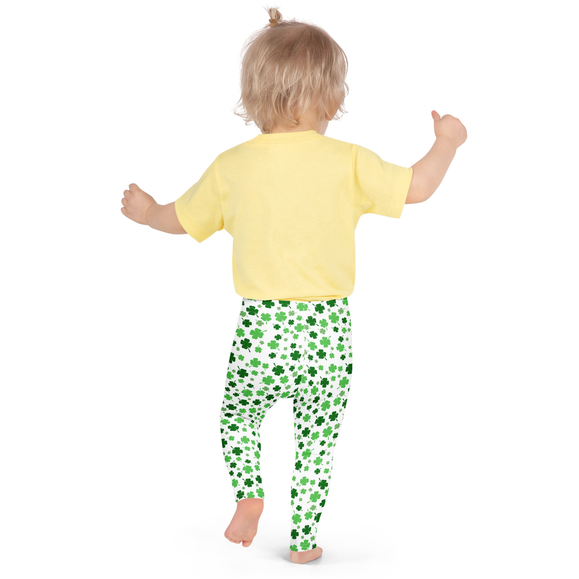 Girls shamrock print buttery soft green leggings with shamrock pattern worn by a child