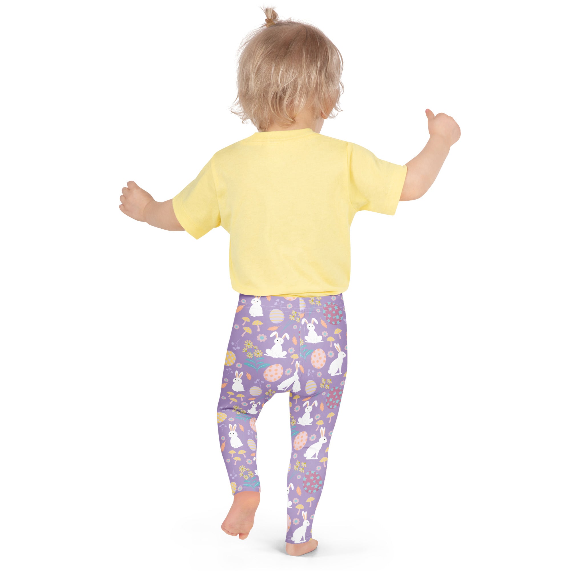 A child wearing girls purple Easter bunny buttery soft leggings with white bunnies eggs mushrooms and flowers design