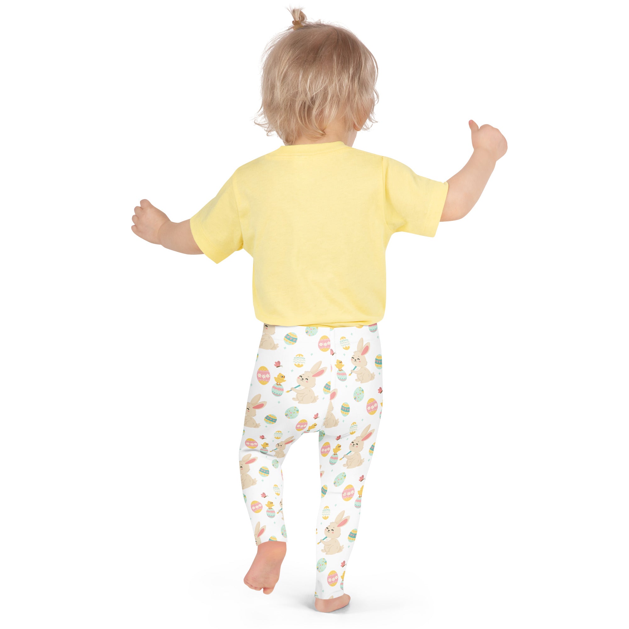 A child wearing girls Easter bunny and chick buttery soft white leggings with colorful prints and a yellow top