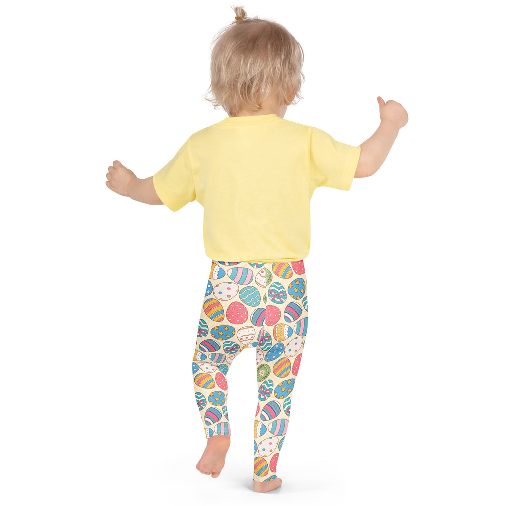 Yellow short-sleeved top paired with buttery soft girls vintage leggings featuring colorful cartoon easter eggs pattern