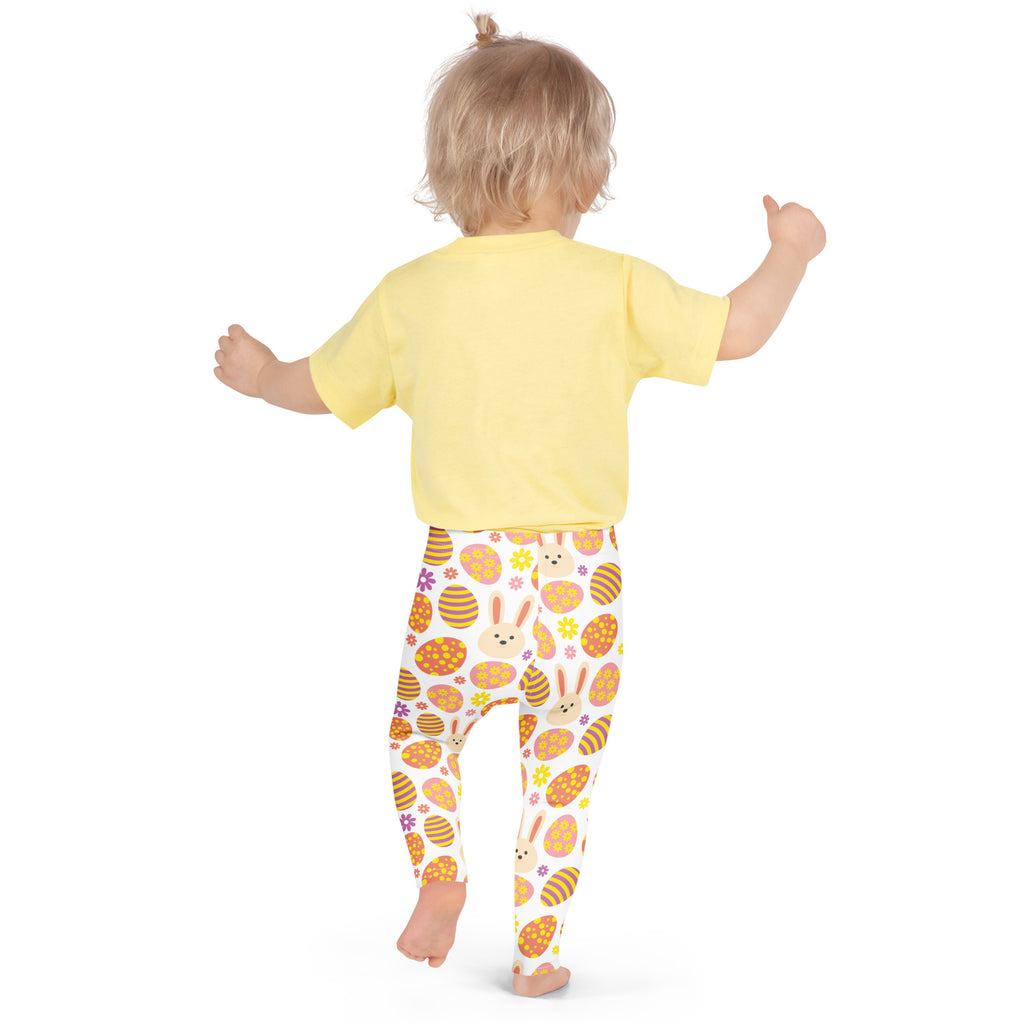 A child wearing girls orange bunny Easter egg buttery soft white leggings with colorful Easter-themed patterns