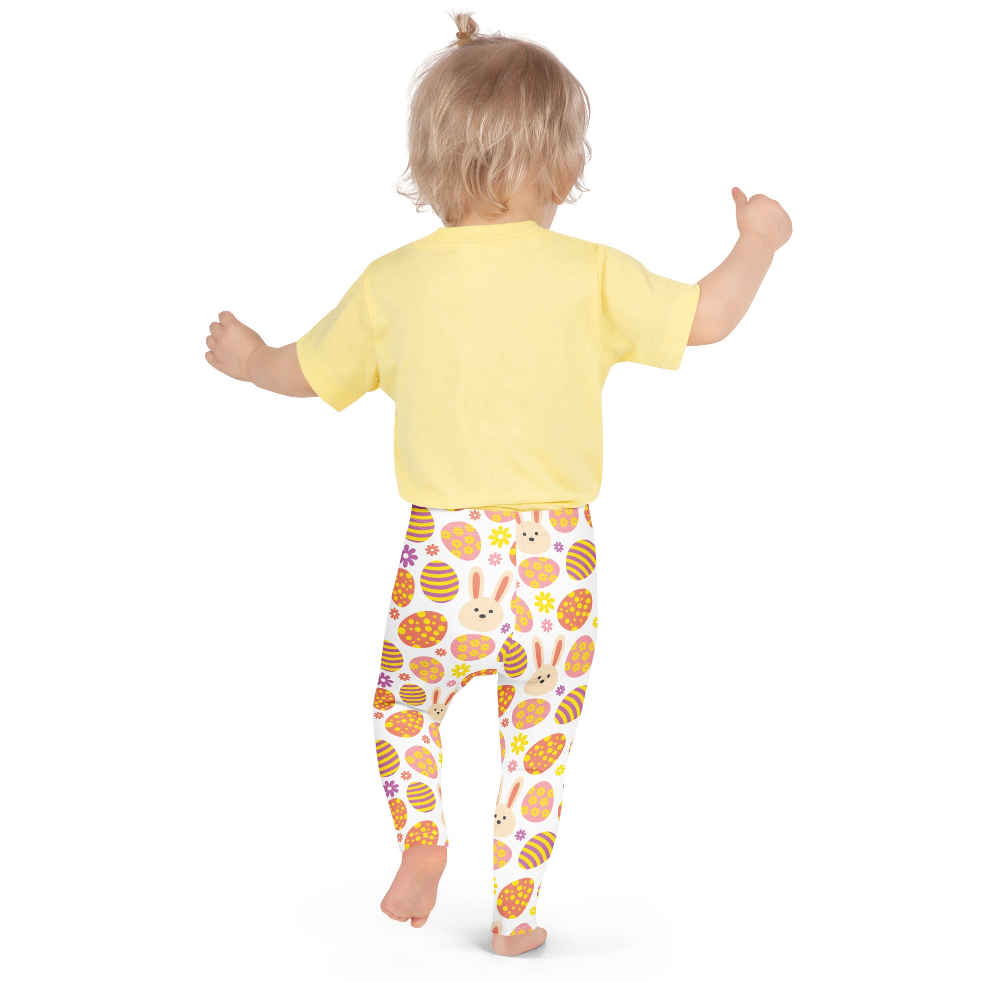 A child wearing girls orange bunny Easter egg buttery soft white leggings with colorful Easter-themed patterns
