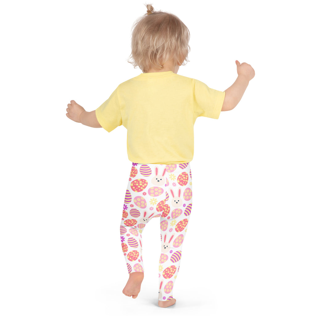 A child wearing girls pink bunny Easter egg buttery soft white leggings with colorful egg patterns and a yellow top