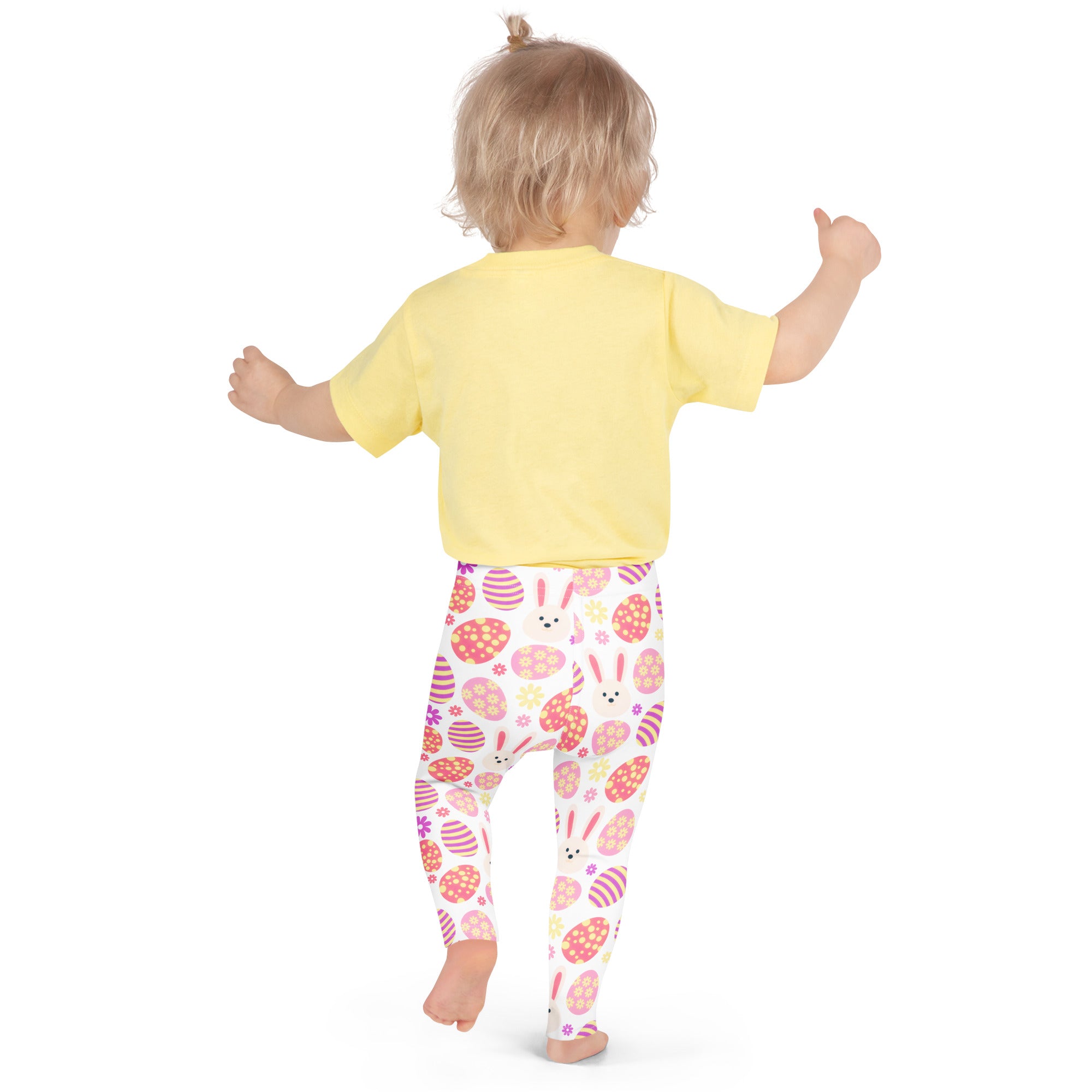 A child wearing girls pink bunny Easter egg buttery soft white leggings with colorful egg patterns and a yellow top