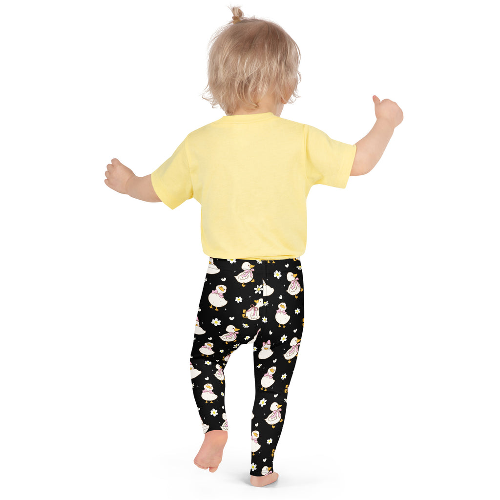 Girls black buttery soft leggings featuring a playful pattern of white ducks with pink bows and yellow flowers