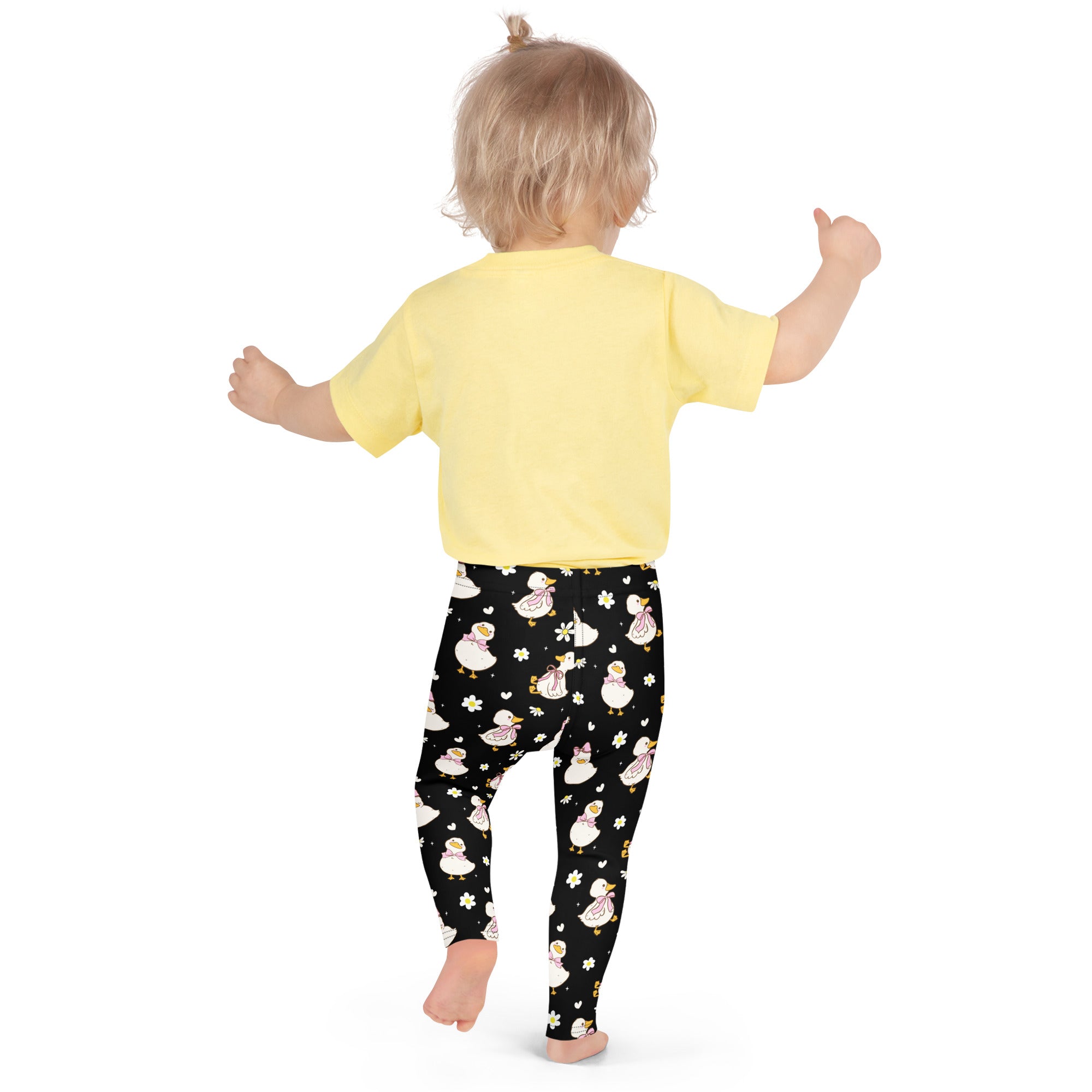 Girls black buttery soft leggings featuring a playful pattern of white ducks with pink bows and yellow flowers