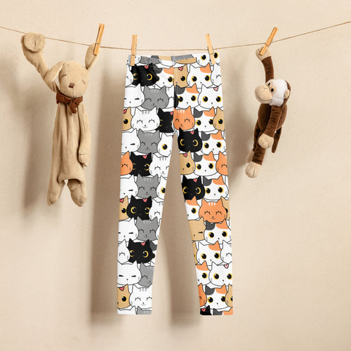 Kids leggings with colorful cute cat pattern hung between plush bunny and monkey toys.
