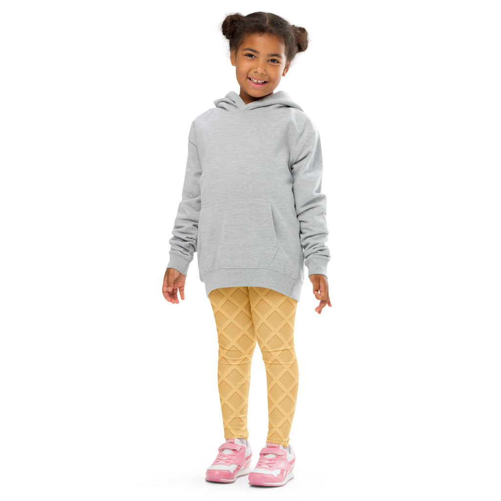 A child wearing buttery soft kids waffle cone yellow diamond patterned leggings with a light gray hooded sweatshirt