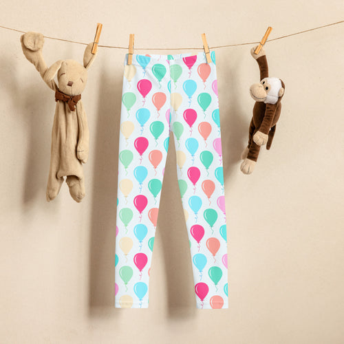 Pastel balloon patterned white girls birthday leggings hanging on a clothesline made of soft fabric
