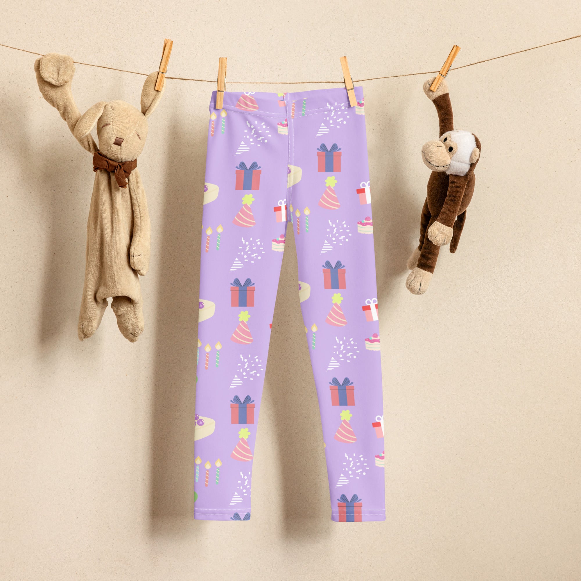 Girls birthday buttery soft leggings in purple with festive birthday pattern of gift boxes party hats and candles