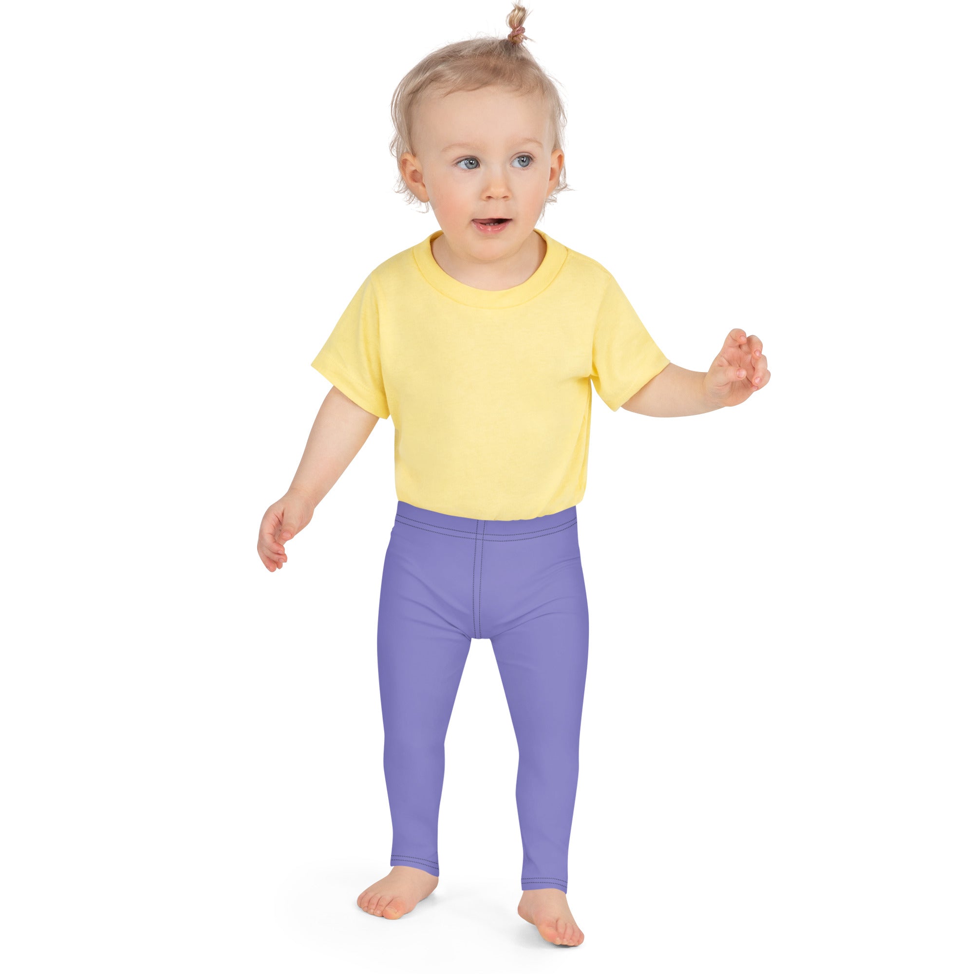 A toddler wearing buttery soft purple leggings paired with a yellow short-sleeved t-shirt