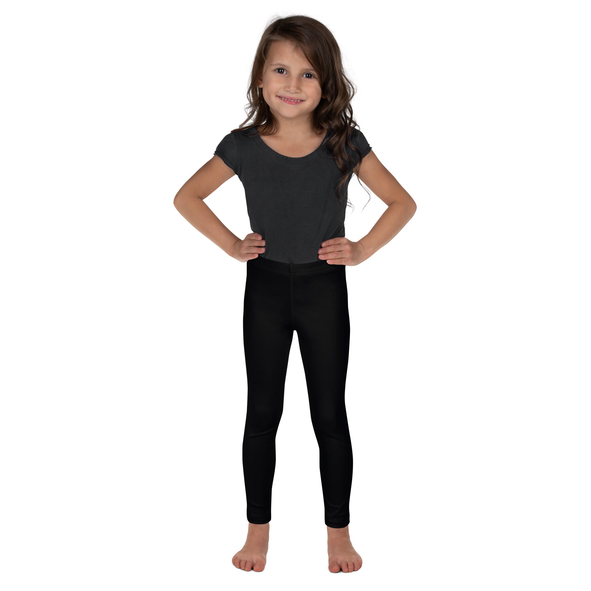 Young girl wearing black buttery soft stretchy leggings designed for kids comfort and flexibility