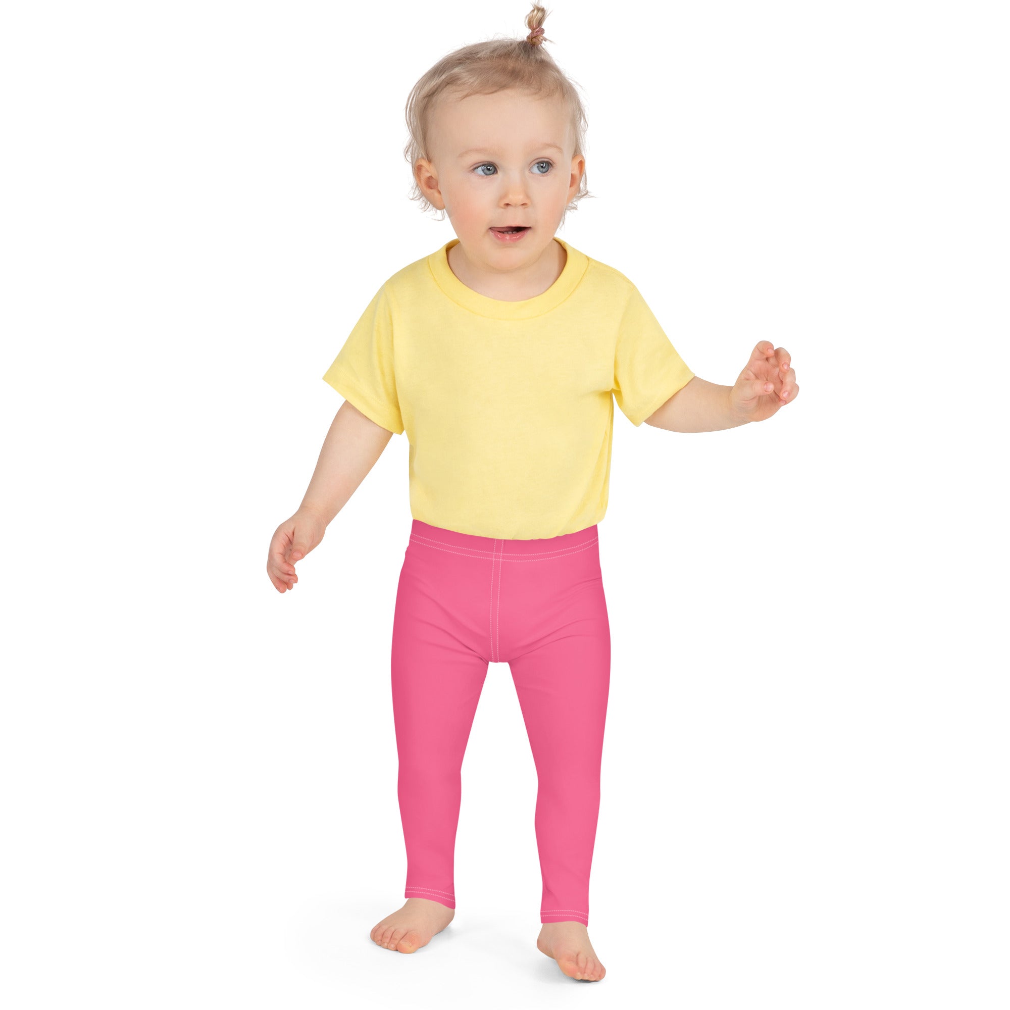 A toddler wearing girls buttery soft pink leggings made of soft fabric with a bright yellow short-sleeved t-shirt