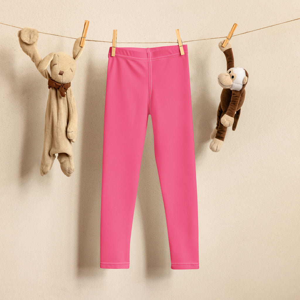 Girls buttery soft bright pink form-fitting leggings hanging on a clothesline showing the front side