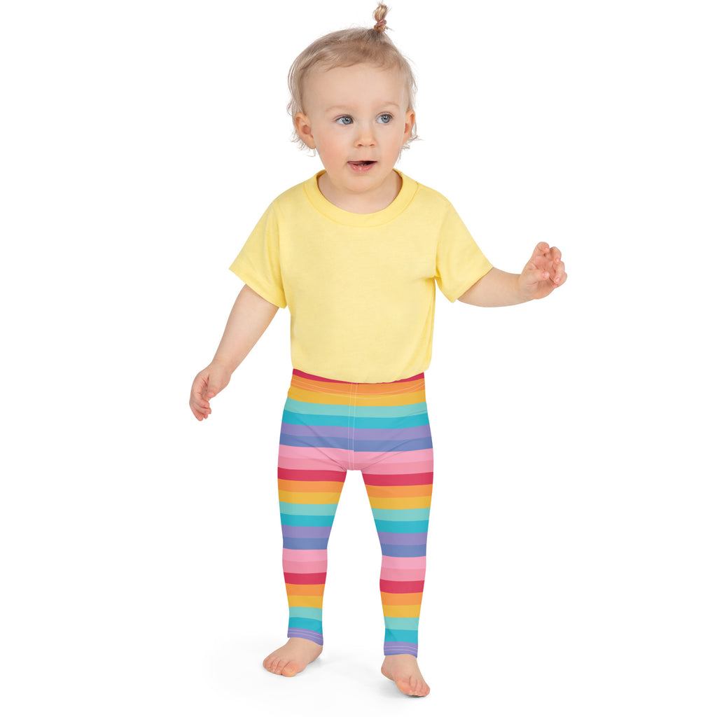 Girls bright rainbow striped buttery soft leggings worn by a toddler showing colorful comfortable fit