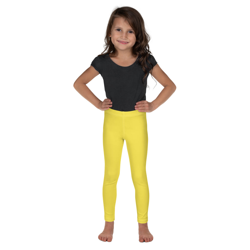 Bright yellow buttery soft kids leggings worn by a young girl featuring a form-fitting design