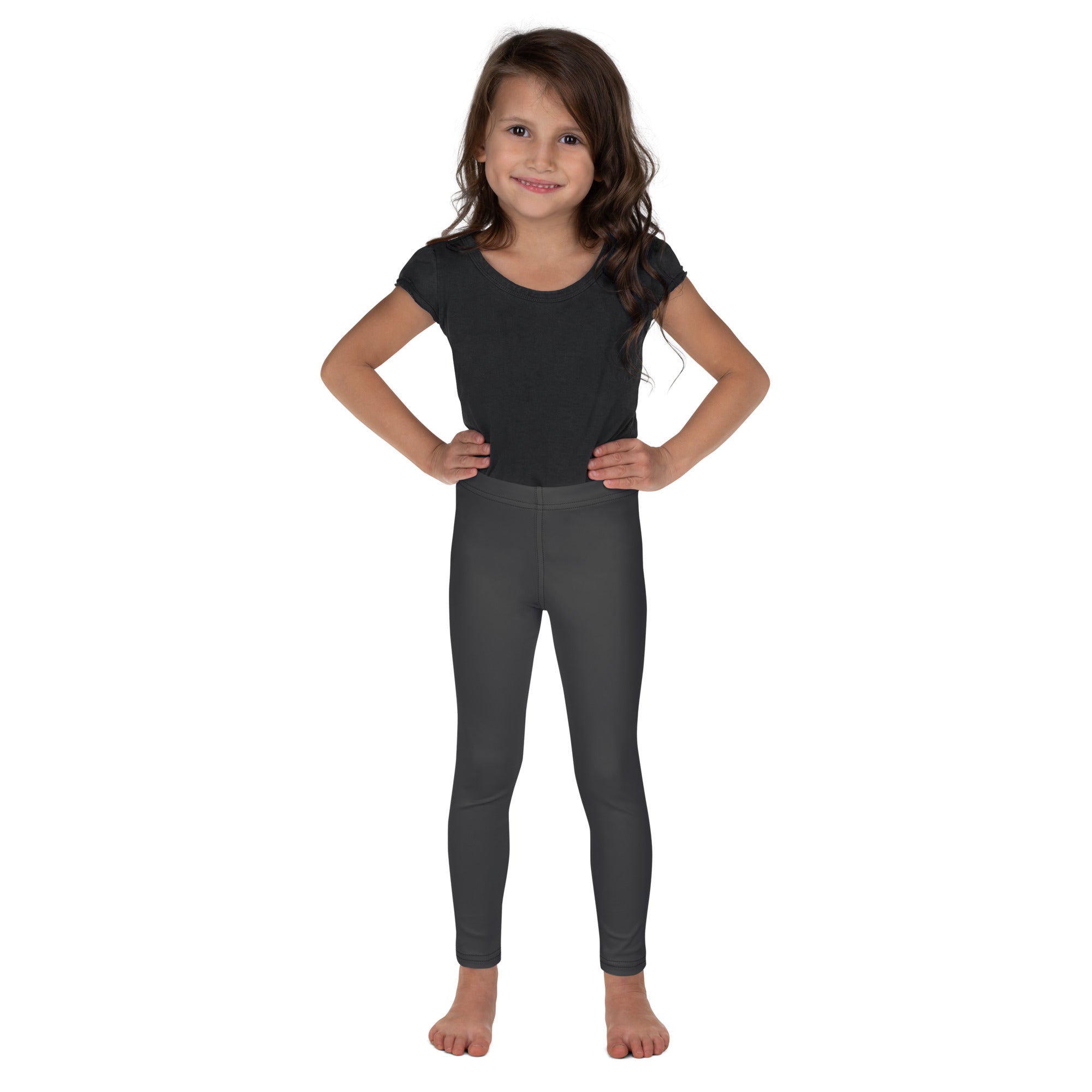 Young girl wearing a black short-sleeved top and kids buttery soft gray leggings in dark gray stretchy fabric