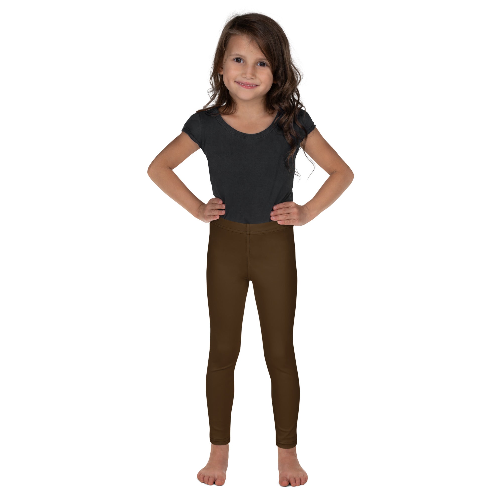 A child wearing buttery soft brown kids leggings paired with a dark gray short sleeve top