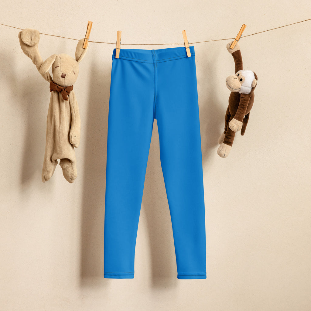 Kids buttery soft blue leggings bright blue form-fitting buttery soft kids leggings hanging on a clothesline