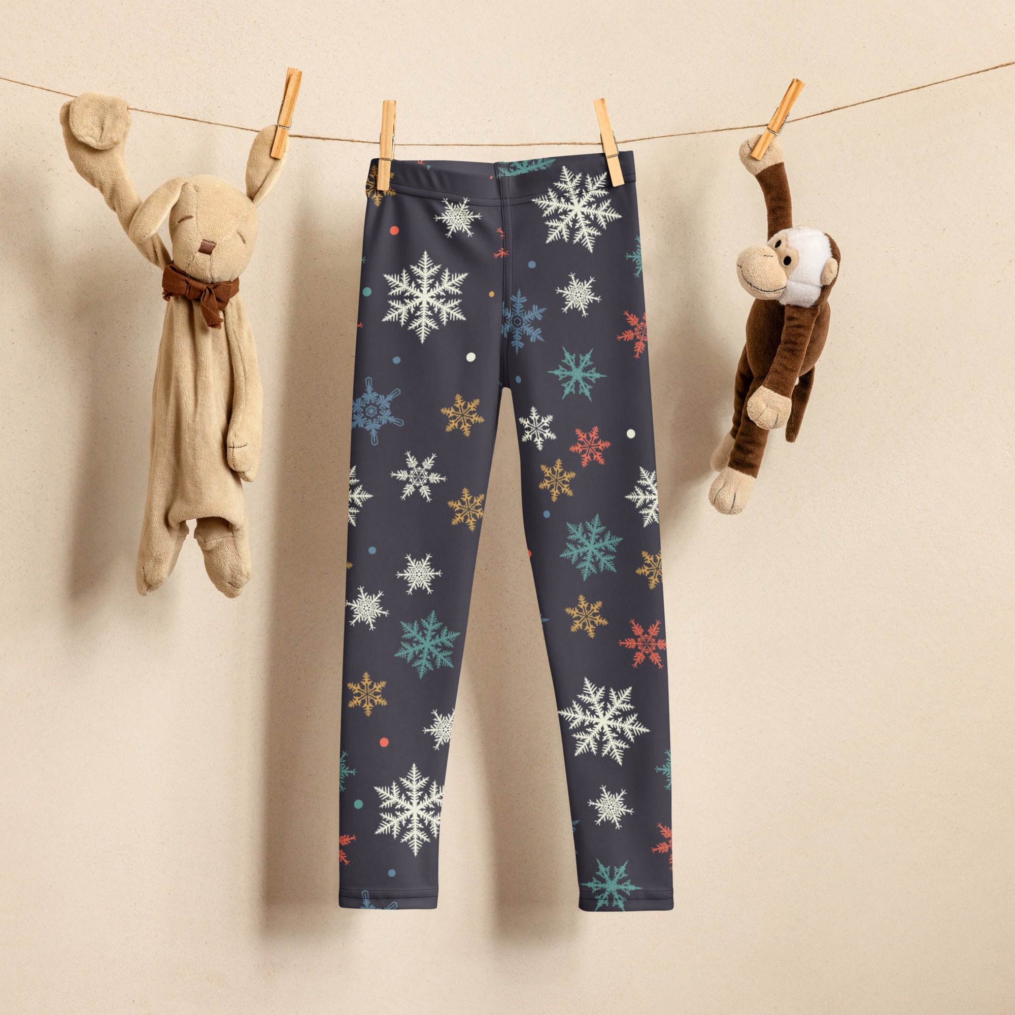 Dark gray kids christmas leggings with colorful white teal gold and red snowflake pattern for festive wear