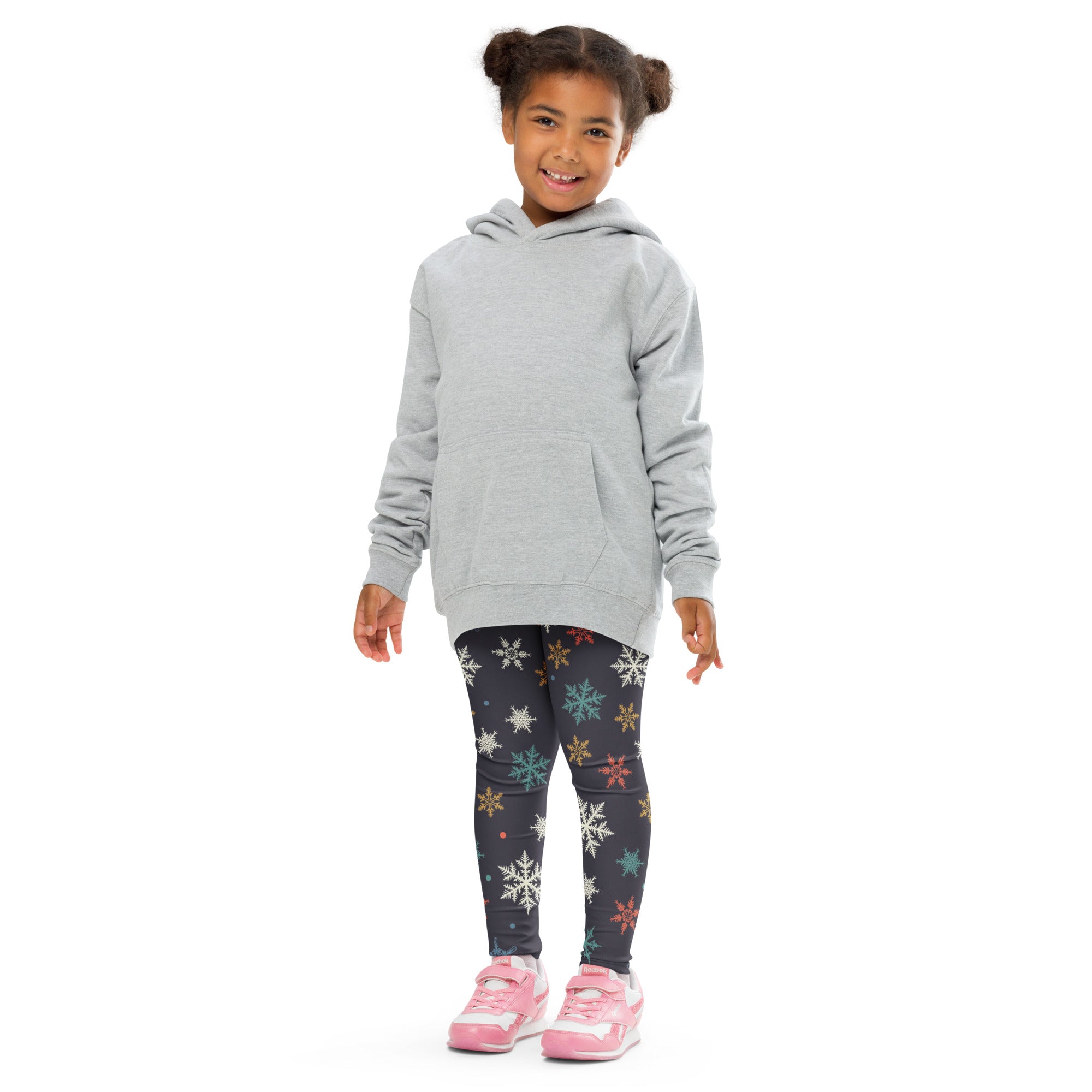 Gray hooded sweatshirt with front pocket and long sleeves paired with festive kids christmas leggings with colorful snowflakes